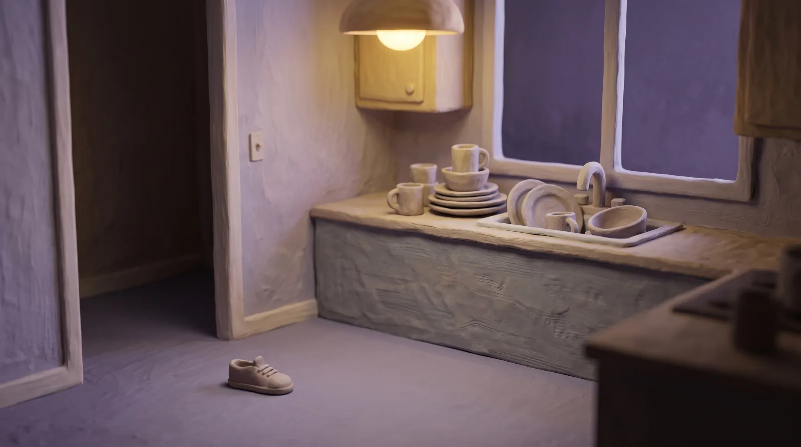 A kitchen counter with stacked dishes and a single child's shoe on the floor near a doorway.